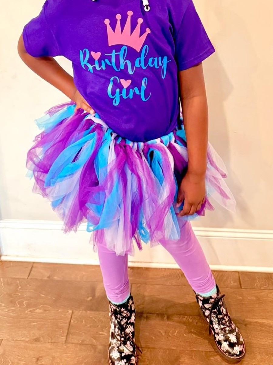 The purple birthday girl tee worn with a purple and blue tulle tutu, lilac leggings and patterned boots.