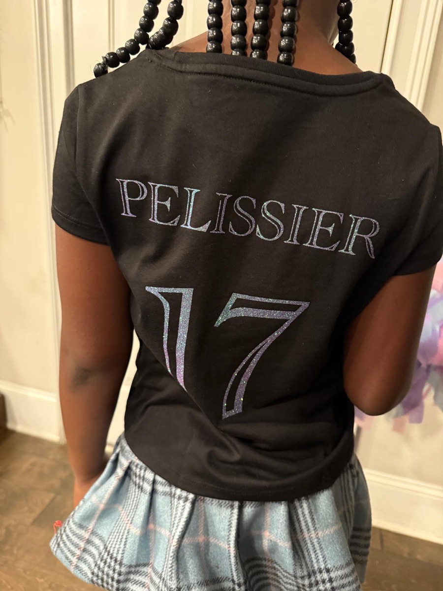 The back of the same cheer tee, printed with a last name and the number 17 in matching glitter.