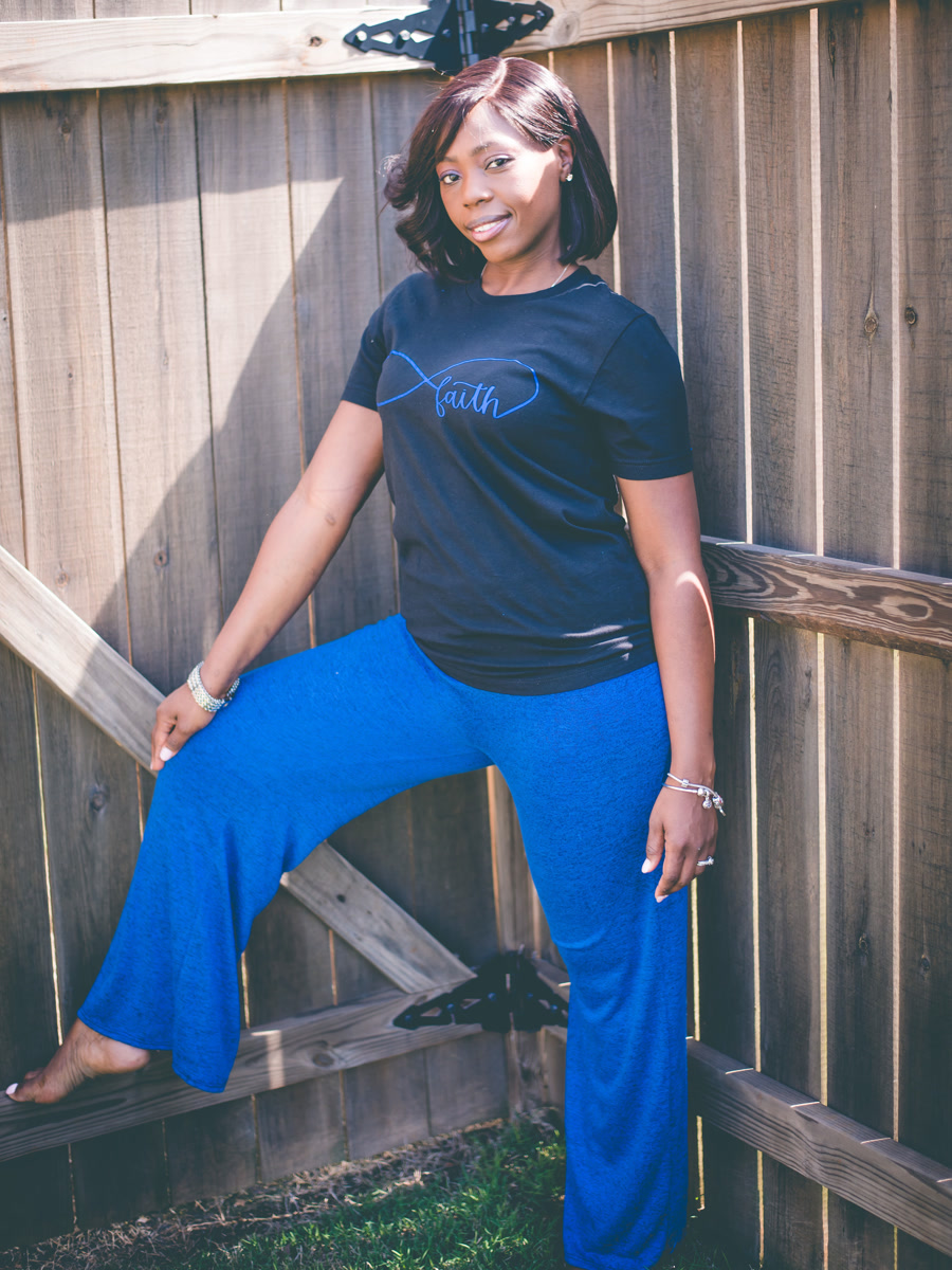 The navy faith tee worn with matching bright blue wide-leg trousers.