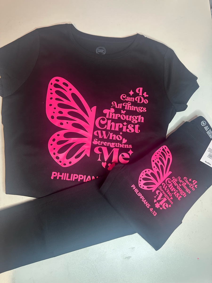 The same Philippians 4:13 butterfly in hot pink on a black tee and matching black pants.