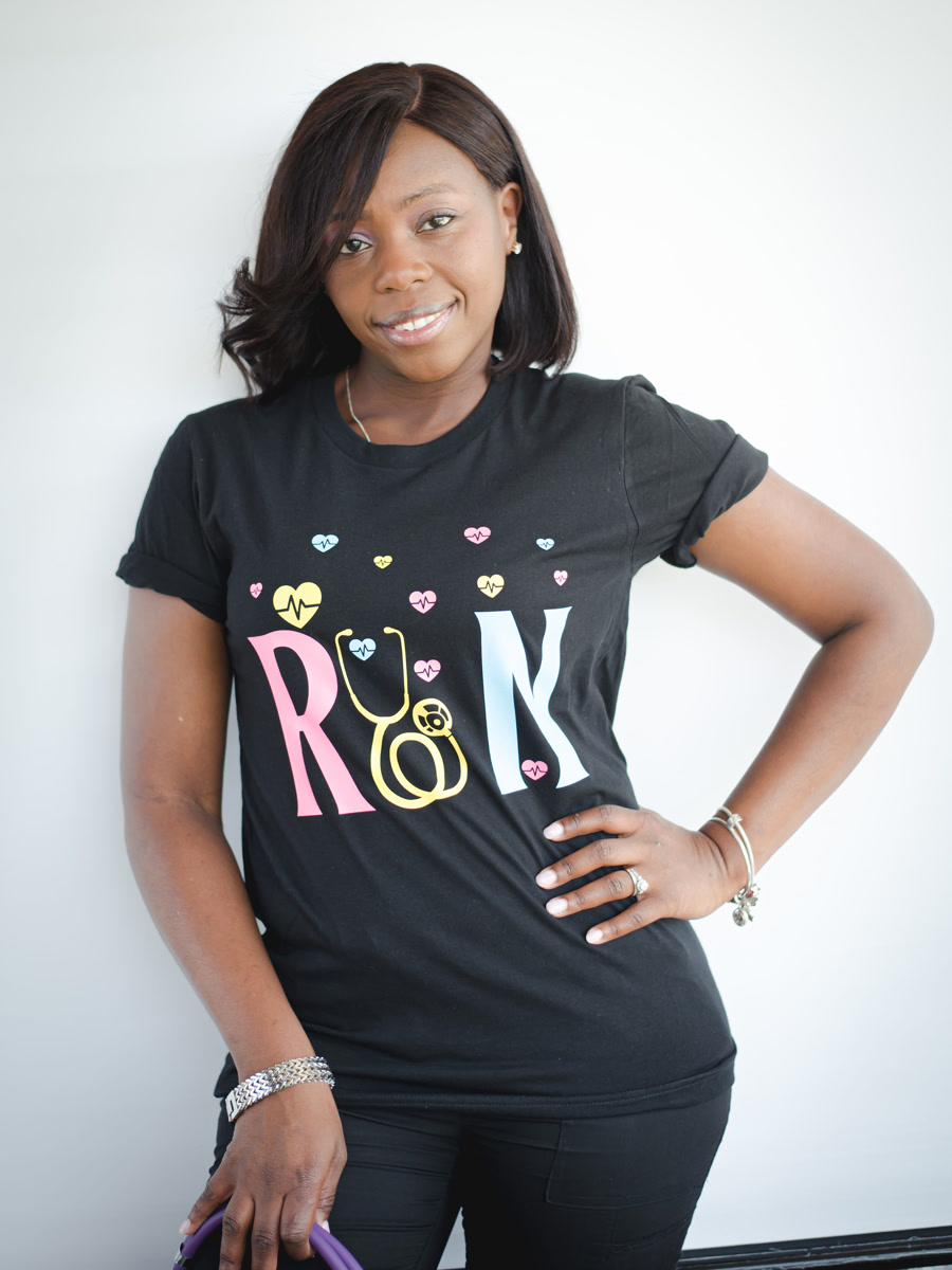 A black tee printed with RN in pastel letters, the N formed from a stethoscope, scattered with small hearts.