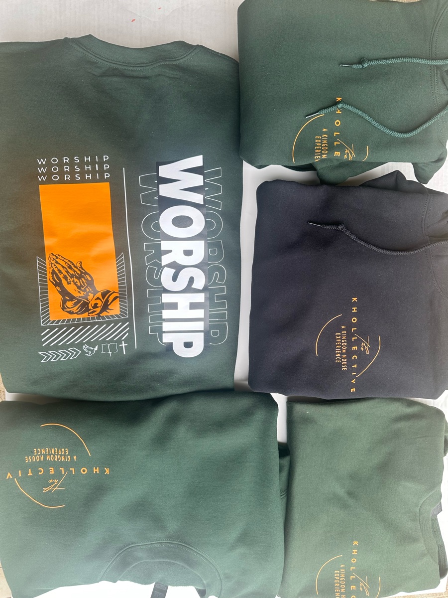 Green and black sweatshirts stacked together for one group order, the top one printed WORSHIP beside praying hands on an orange block.