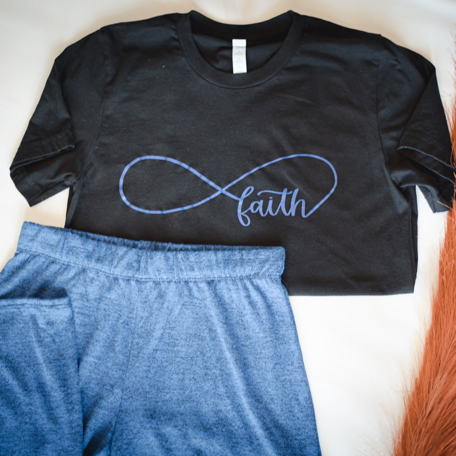 A finished faith print tee folded with matching sweatpants.